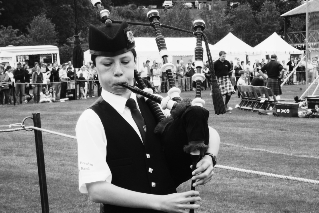 bagpiper playing at highland games